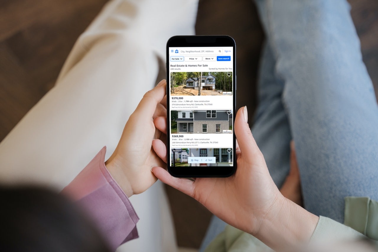 Buyer looking at online real estate listings on their smartphone
